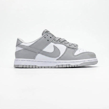 A Nike Dunk sneaker in a light gray and white colorway, shown from the side profile against a clean white background.