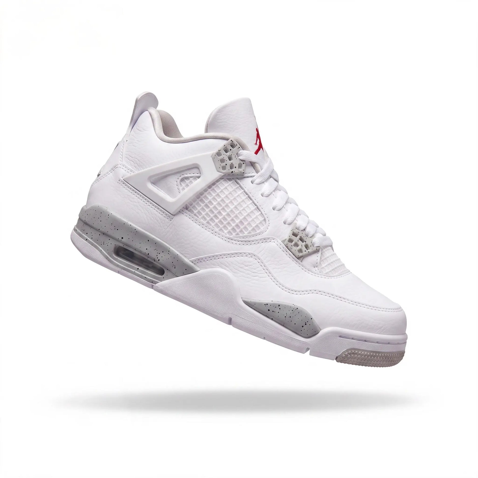 A white Air Jordan 4 sneaker floating against a solid white background, featuring gray suede overlays, a white mesh upper, and a small red Jumpman logo on the tongue.