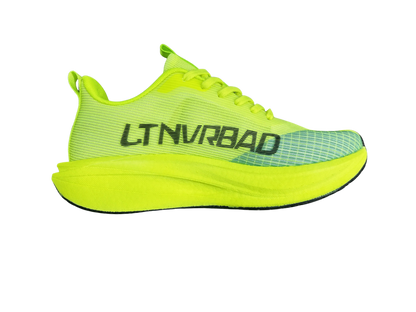 A bright neon yellow-green athletic shoe shown in a side profile view against a solid white background. The shoe features a textured mesh upper, a thick cushioned sole, and the brand name 'LTNVRBAD' printed vertically in black on the side.