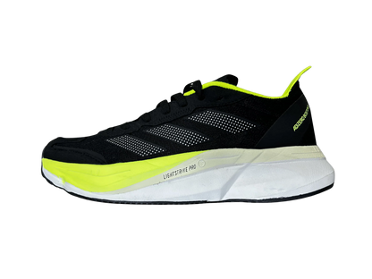 A black running shoe with bright neon yellow-green accents and a white midsole, shown in a side profile on a plain white background.