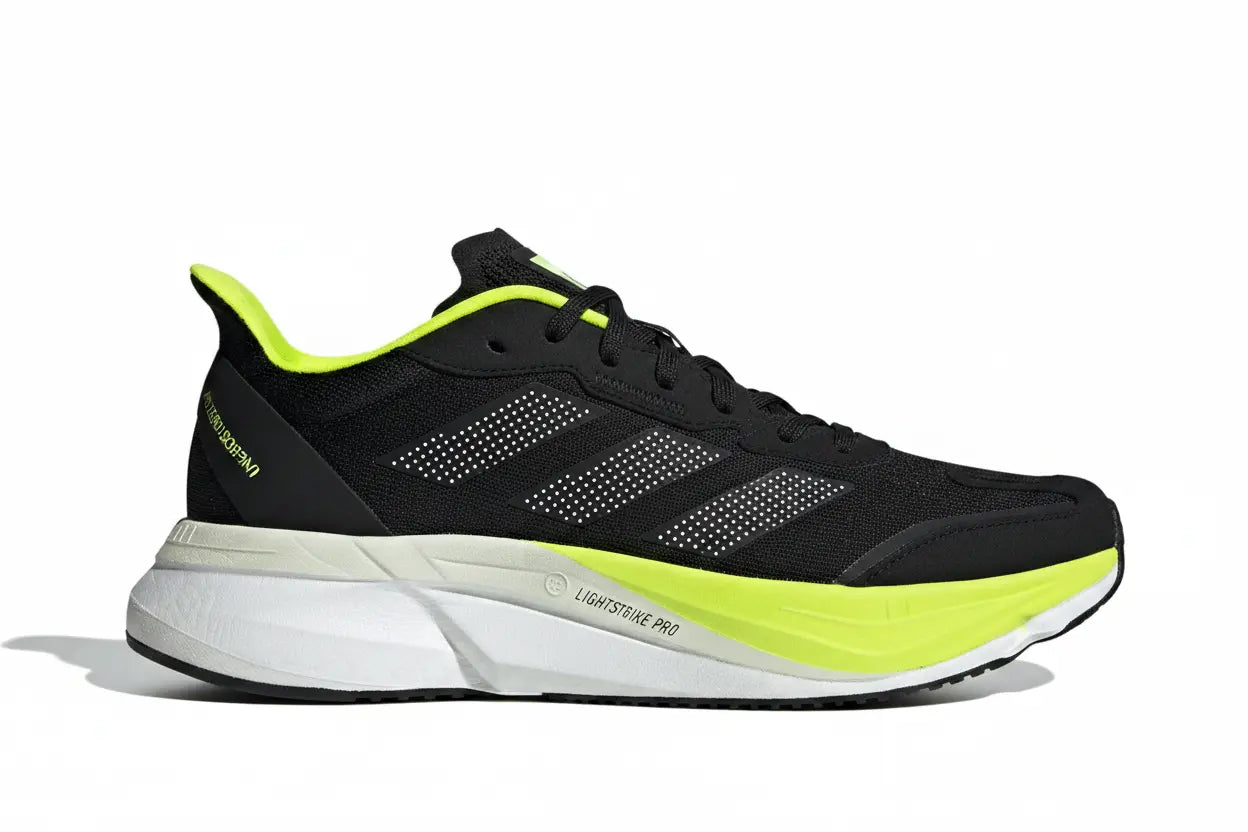 An Adidas Lightstrike Pro running shoe in black with bright neon yellow-green accents on the collar, tongue, and midsole, set against a plain white background.