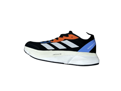 A single Adidas Yeezy Boost 380 sneaker shown from a side profile view against a plain white background. The shoe features a black upper with white mesh panels, a prominent orange flame design, a blue heel accent, and a thick white midsole with 'BOOST 380' printed vertically.