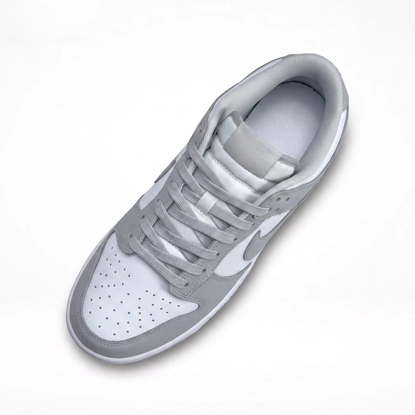 A low-top Nike sneaker in light gray and white, shown from a top-down angle on a clean white background.