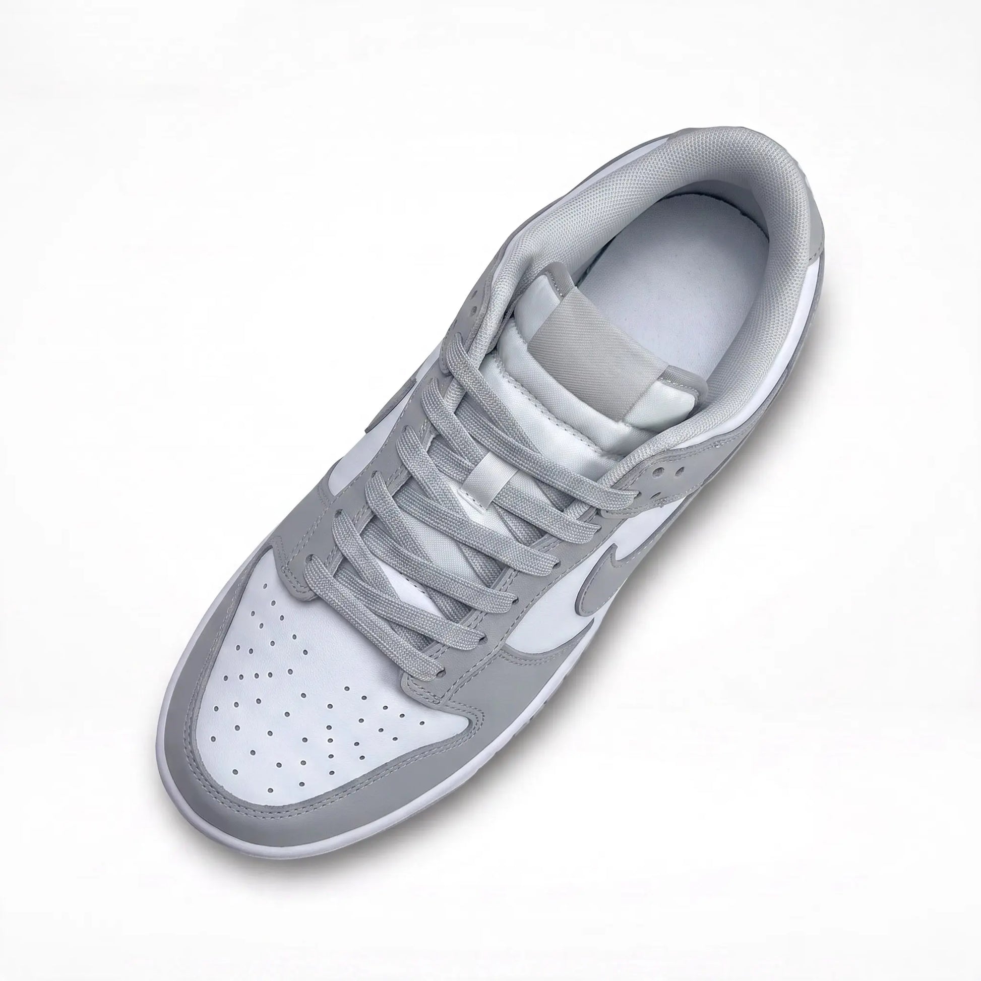 A low-top Nike sneaker in light gray and white, shown from a top-down angle on a clean white background.
