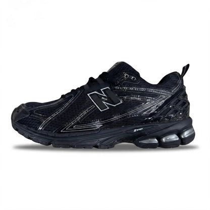 A black New Balance athletic sneaker with metallic silver accents, featuring the signature 'N' logo on the side, a textured mesh upper, and a cushioned sole with visible air units, shown against a plain white background.
